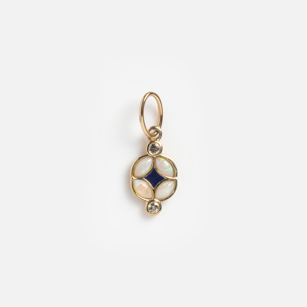 The Solid Gold Art Deco Opal Charm features a circular design with a central dark blue diamond-shaped stone, four oval opals, and two small round diamonds, displayed on a plain white background.