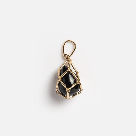 The Solid Gold Tethered Obsidian Charm Sample features a polished black stone encased in gold wire as a pendant with a top loop, shown on a plain white background.