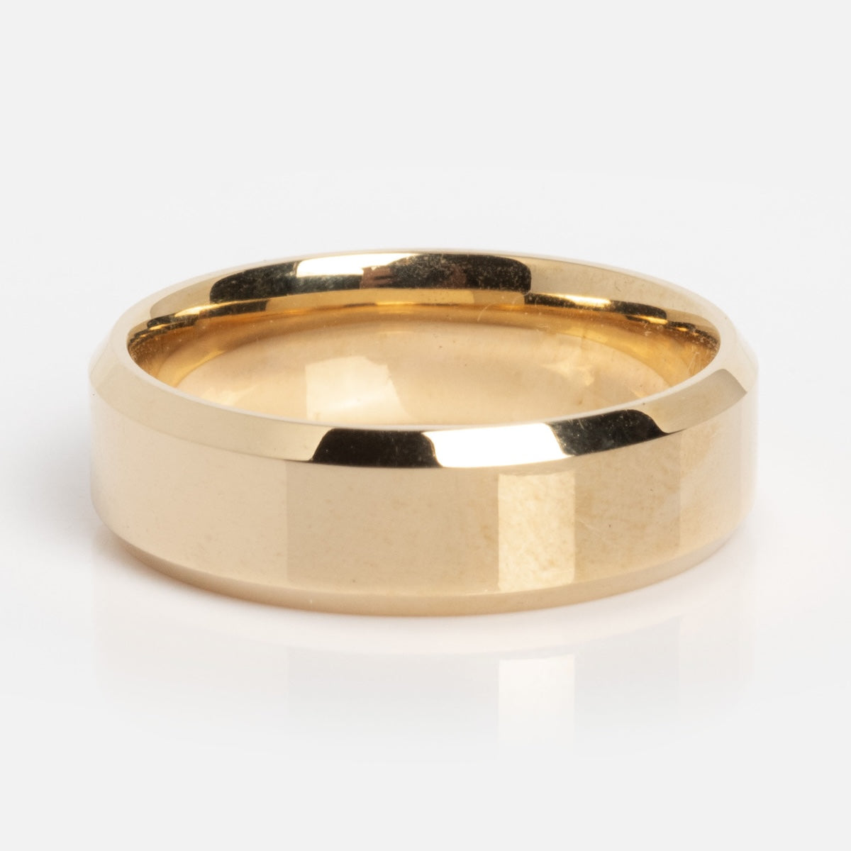 The Solid Gold Classic Band Sample Size 7 is a shiny 14k gold ring with a flat, faceted surface and smooth edges, shown on a white background.