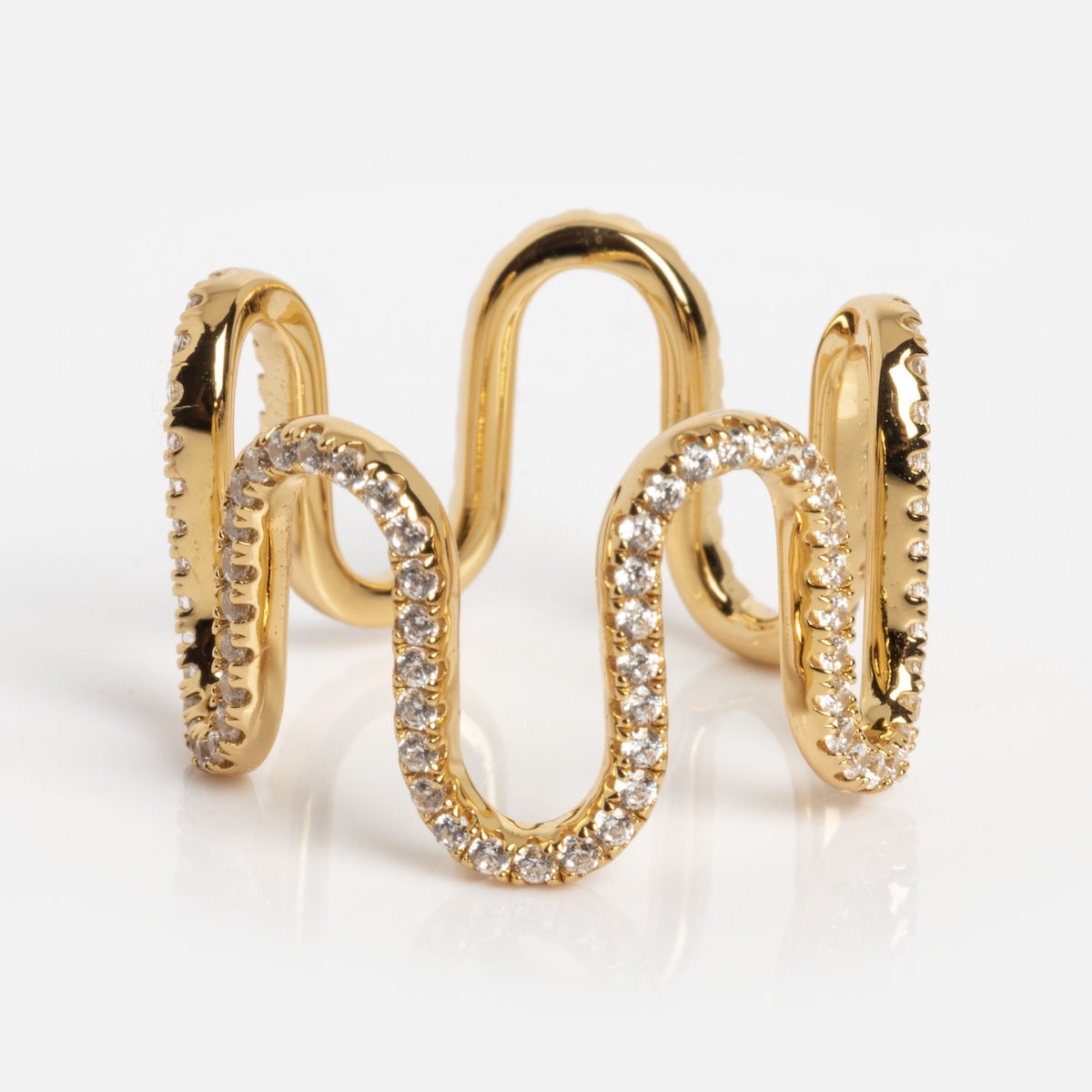 The Golden Waves White Topaz Ring in sample size 7 features a wavy, open design crafted from 14k gold vermeil over silver and is adorned with small white topaz gemstones along the curves, shown on a white background.
