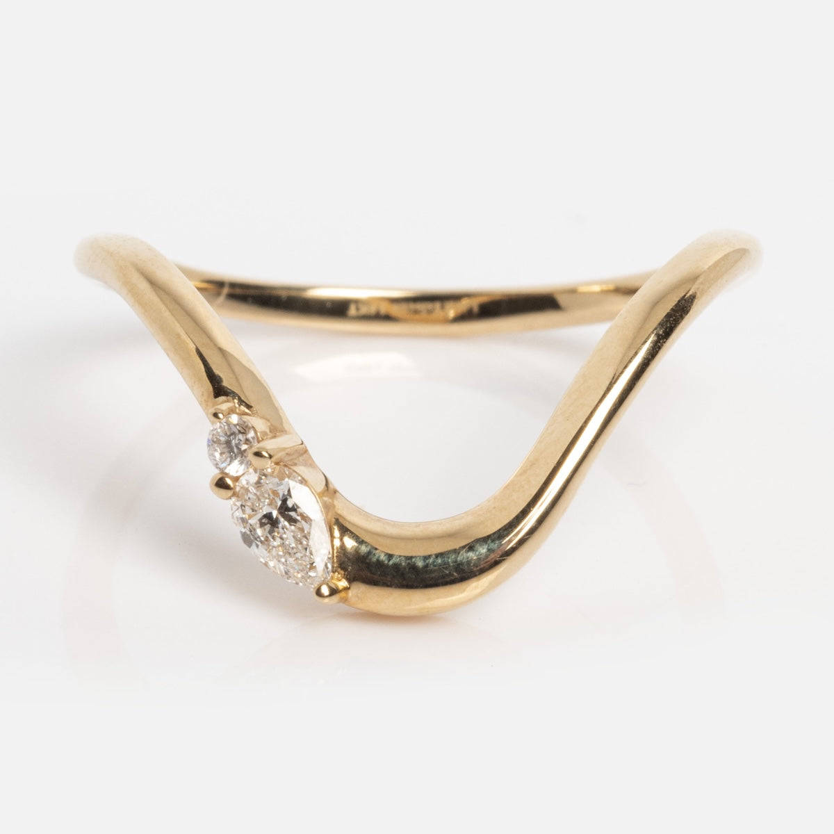 The Solid Gold Diamond Arched Band, sample size 7, is a 14k yellow gold ring with a V-shaped band and three small round lab diamonds clustered at the center, shown against a plain white background.