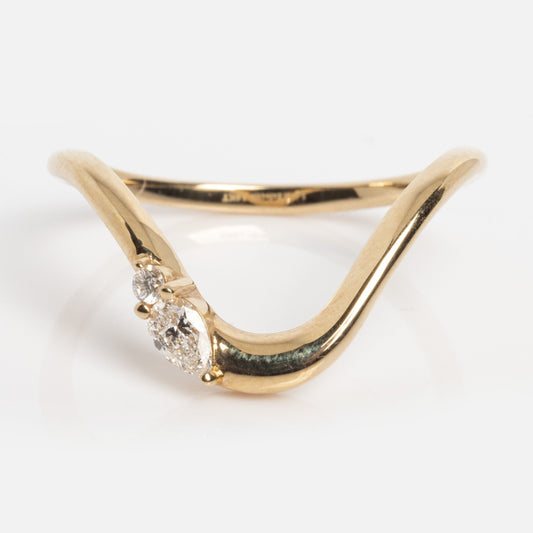 The Solid Gold Diamond Arched Band, sample size 7, is a 14k yellow gold ring with a V-shaped band and three small round lab diamonds clustered at the center, shown against a plain white background.