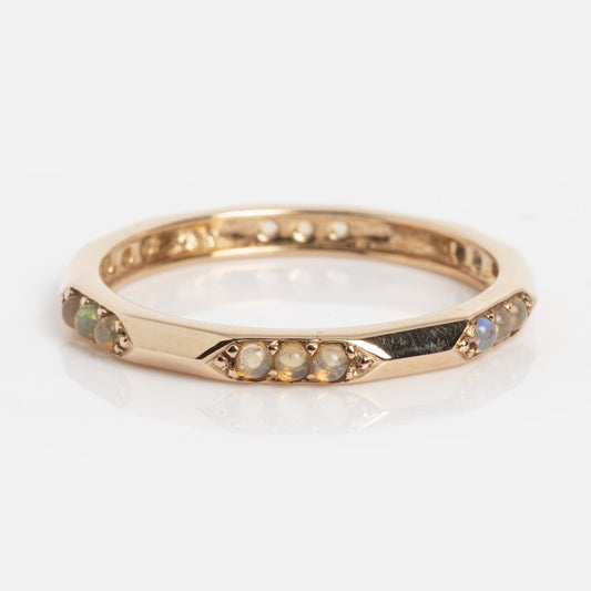 The Dainty Opal Stacking Ring (Sample Size 7) features a 1.5 mm thin 9k solid yellow gold band with alternating small round Ethiopian opals and pearls set delicately around the band.