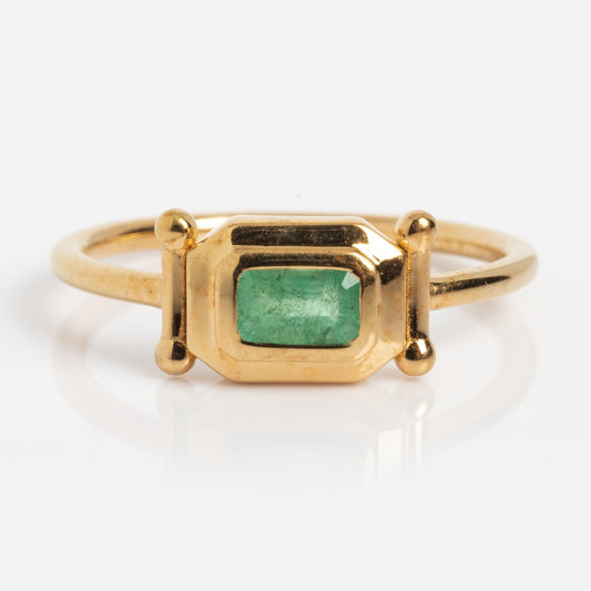 The Vintage Inspired Emerald Bar Ring Sample Size 7 features a rectangular emerald set in a geometric 14k yellow gold bezel with gold spheres on each side, shown on a white background.
