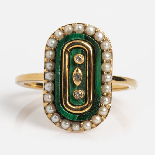 The Vintage Inspired Malachite Signet Ring Sample Size 7 is a 14k yellow gold vermeil ring with an oval green malachite center, surrounded by freshwater pearls and three vertically set small diamonds.