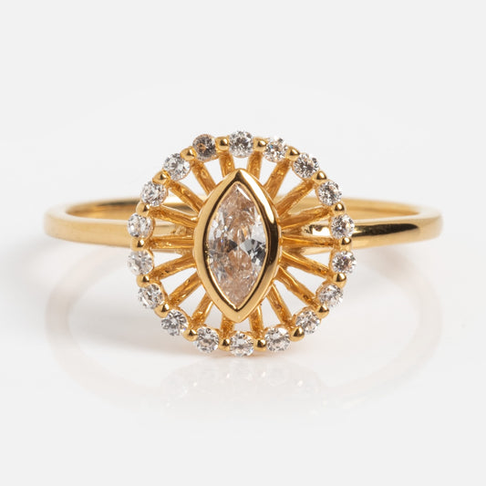The Vintage Inspired Starburst Halo Ring Sample Size 7 features a marquise-cut central diamond with a sunburst halo of round diamonds on a slim 14k yellow gold vermeil band, shown against a white background.