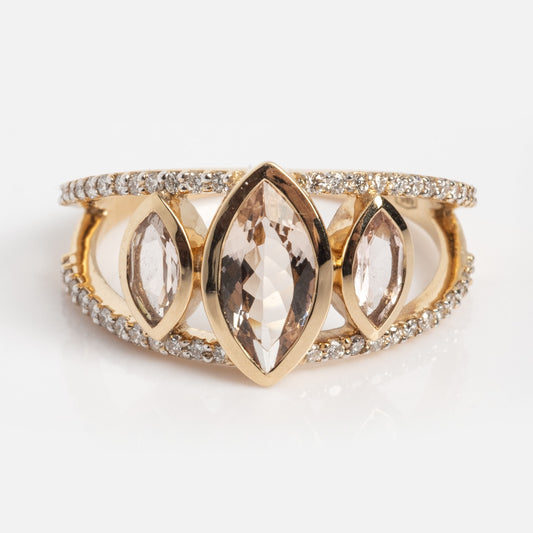 The Solid Gold Floating Morganite Trio Ring (Sample Size 7) features three marquise-cut morganite stones at the center and two rows of round lab diamonds on the band, showcased on a white background.