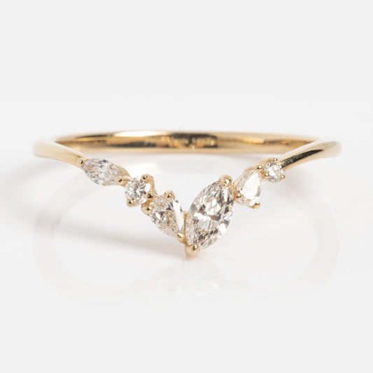 The Solid Gold Mixed Diamond Arch Band in size 7 is a delicate 14k gold ring with an arch design, set with five small, clear, mixed-shape lab diamonds clustered in the center.