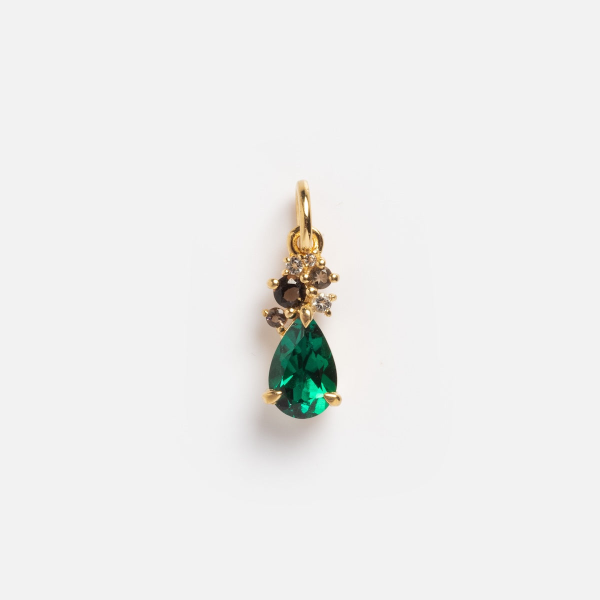 The Slim Emerald Cluster Charm Sample is a gold pendant with a teardrop-shaped green gemstone and three small round stones clustered above it, displayed on a plain white background.