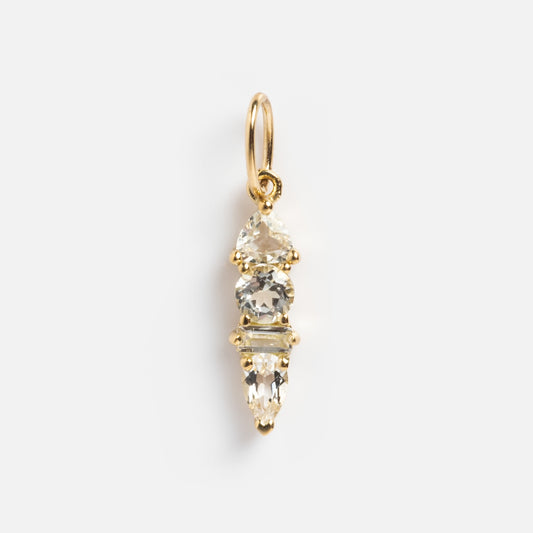 The Solid Gold Modern Ombre Birthstone Charm features three clear gemstones in unique shapes stacked vertically, finished with a small gold loop for chain attachment, displayed on a plain white background.