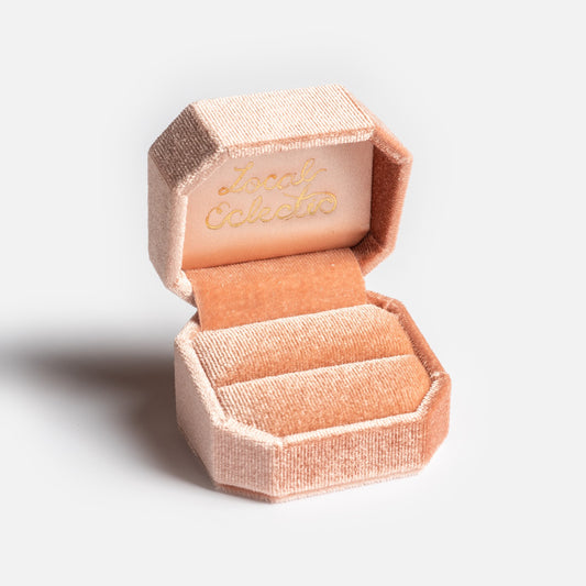 The Fancy Velvet Ring Box features blush pink velvet in an octagonal shape, a soft interior, and "Local Eclectic" embossed in gold inside the lid—perfect for showcasing your ring on special occasions.