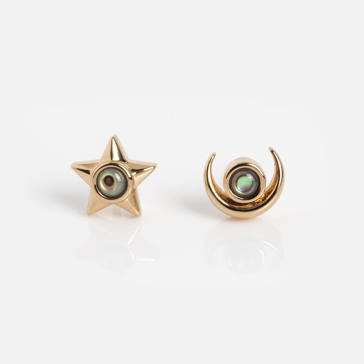 From the Lucky Star and Moon Studs collection, these gold earrings—a five-pointed star and a crescent moon—each showcase a luminous abalone gem at the center, elegantly set against a plain white background.