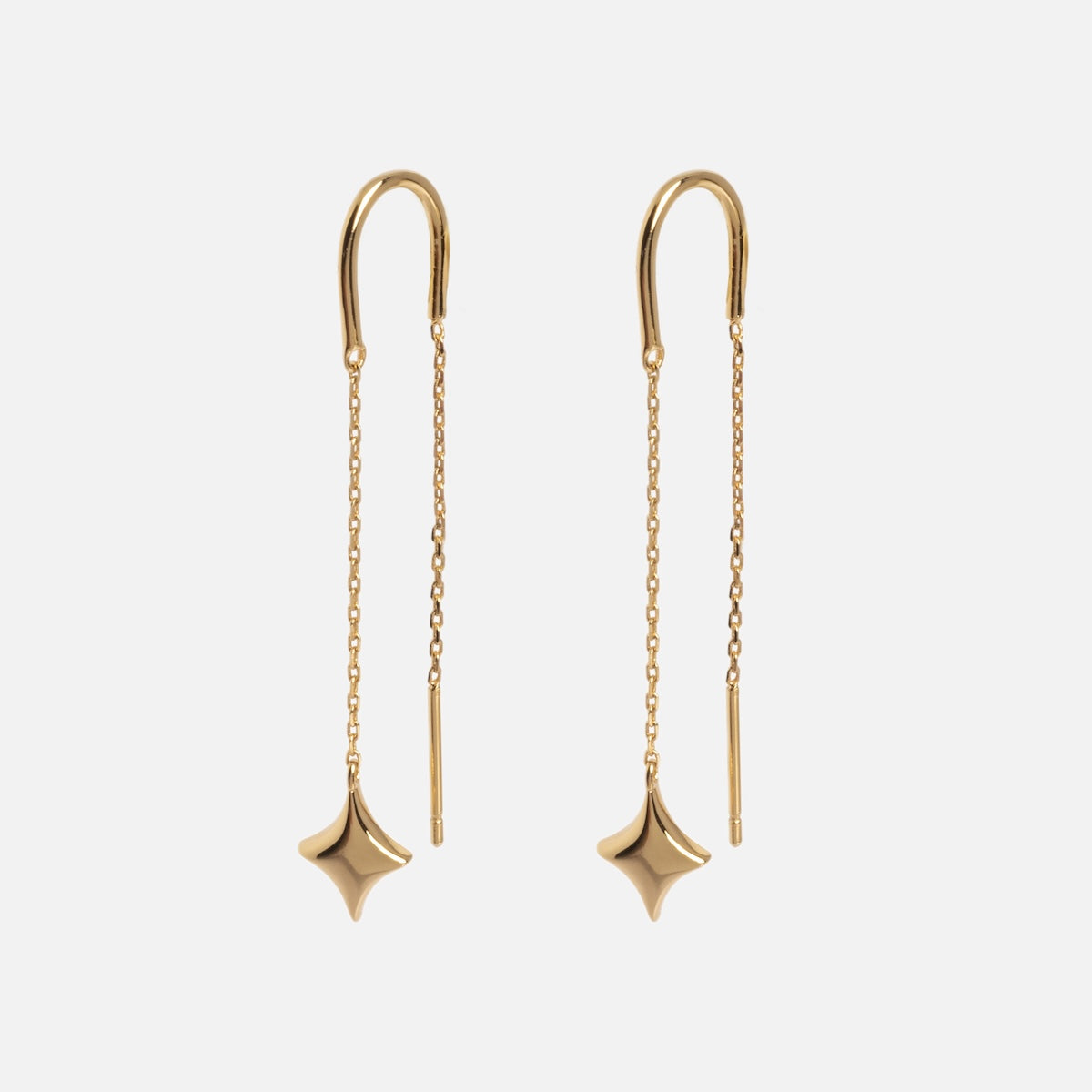 The Lustra Star Threader Earrings feature delicate gold chains with small, smooth four-pointed star charms and slender bars at the ends, all set against a plain white background.