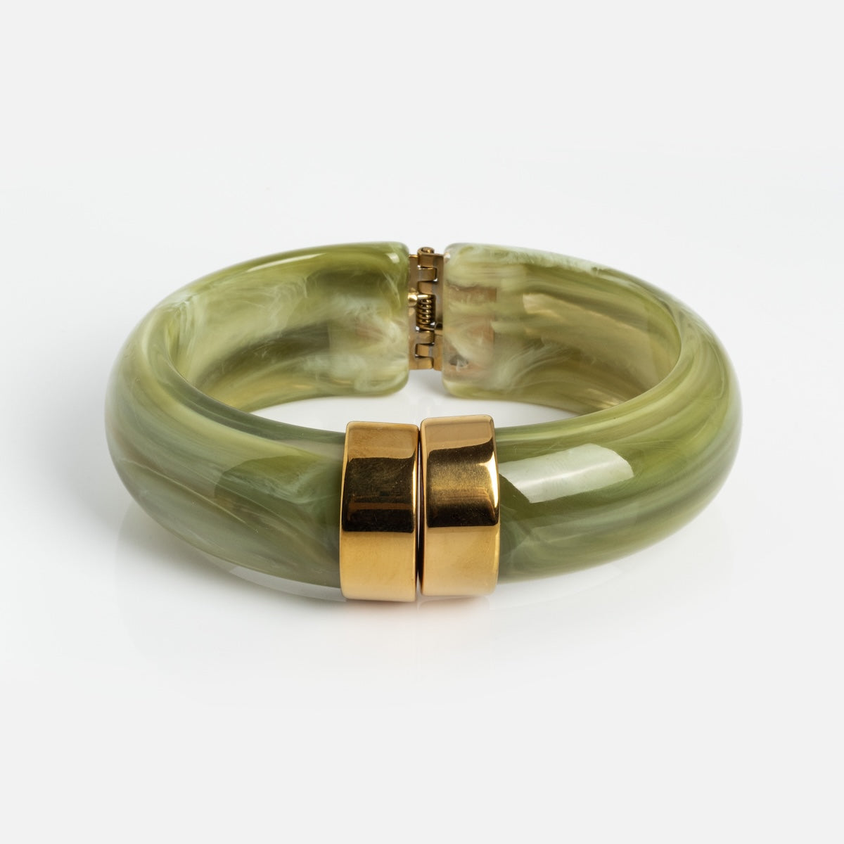 The Sylune Bangle Bracelet features chunky, translucent green marbled resin with a shiny gold clasp. It measures 22.4 mm wide and is shown on a plain white background.