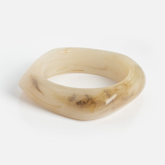 The Bangle Bracelet is a chunky, square-shaped resin accessory in creamy beige with brown and amber marbled accents, shown on a white background.
