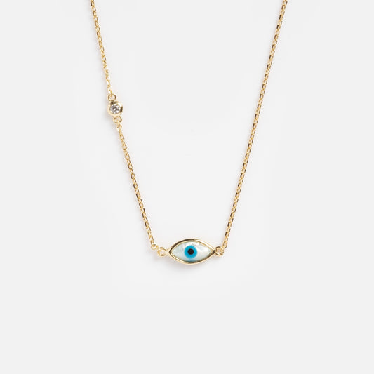 The Madison Evil Eye Necklace is a gold vermeil chain with an evil eye pendant, featuring a blue center and a sparkling cubic zirconia accent, shown against a plain white background.