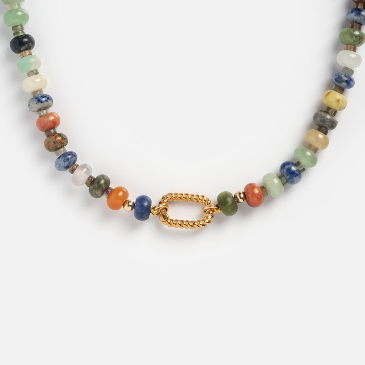 A close-up of the Macey Customizable Beaded Charm Holder Necklace, showcasing round multicolored gemstone beads and a twisted oval gold clasp at the center, set against a plain white background.