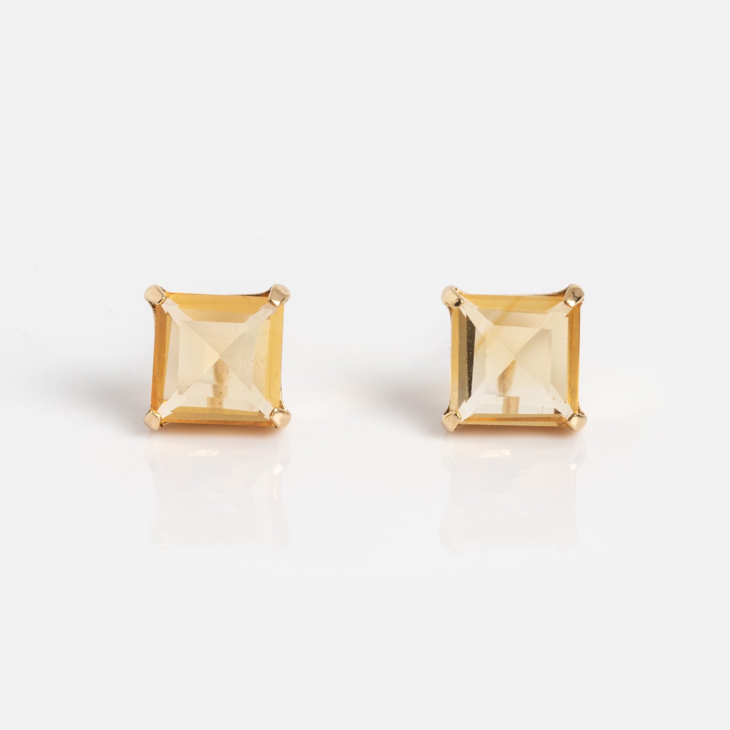 The Solid Gold 2025 November Capsule Classic Citrine Stud Earrings feature square-cut yellow citrine gemstones in four-prong gold settings, shown against a white background.