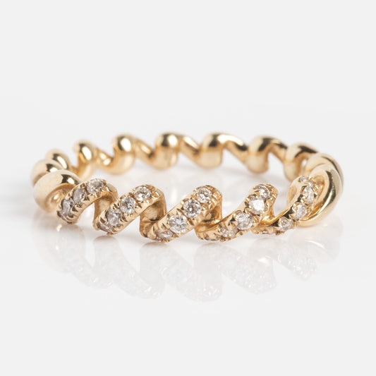 The 14k Fated Twist Diamond Ring features a twisted band with alternating smooth gold and sparkling diamond-encrusted sections.