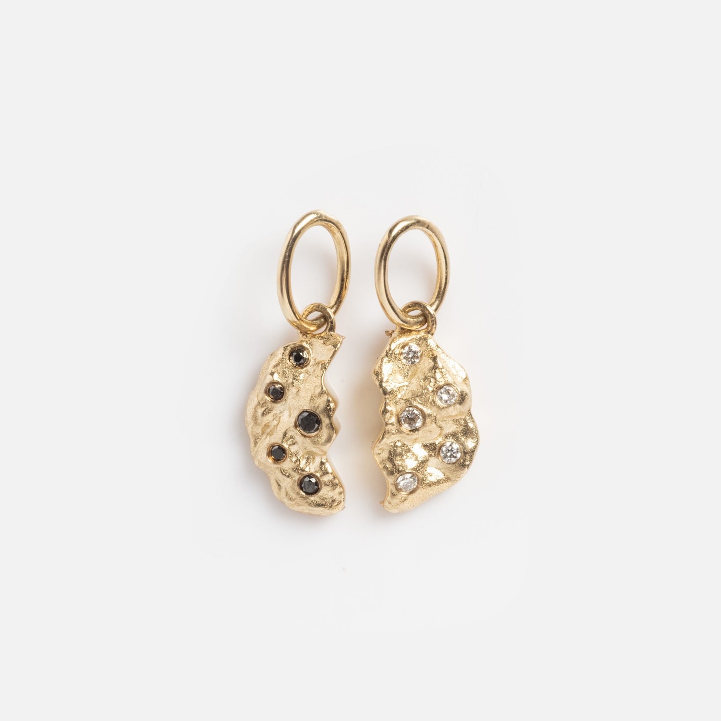 The Levain Bakery x Local Eclectic Solid Gold Share a Cookie Friendship Charms feature two textured, irregular gold pieces with small gemstones, each attached to circular loops and shown on a plain white background.