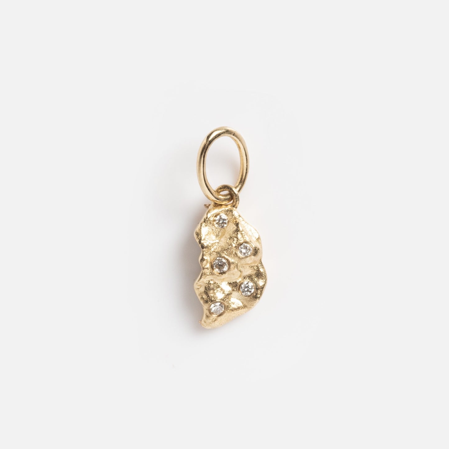 The Levain Bakery x Local Eclectic Solid Gold Share a Cookie Friendship Charm features a small, textured gold pendant with an irregular shape and sparkling stones, attached to a simple gold loop, shown on a white background.