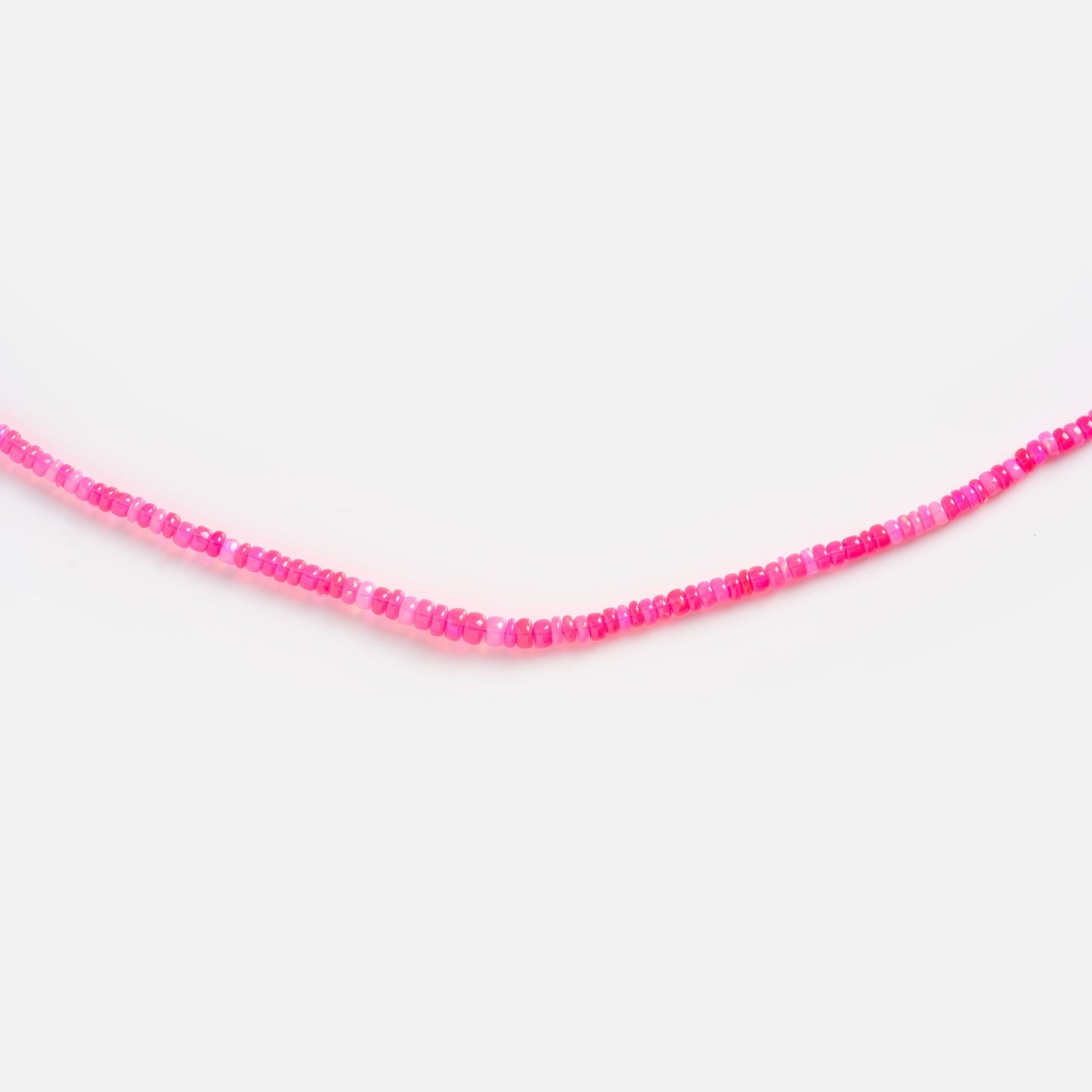 The Beaded Gemstone Necklace features small, round pink beads in varying shades, strung along a slim 18k gold plated strand and displayed against a plain white background.