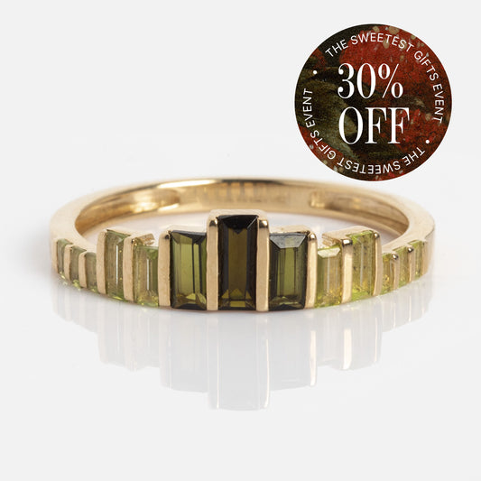The 10k Green Tourmaline Skyline Band by Claire Guo Jewelry features rectangular green tourmalines in a yellow gold band, set against a white background. A circular sticker at the top right says "30% OFF" and "THE SWEETEST GIFTS EVENT.