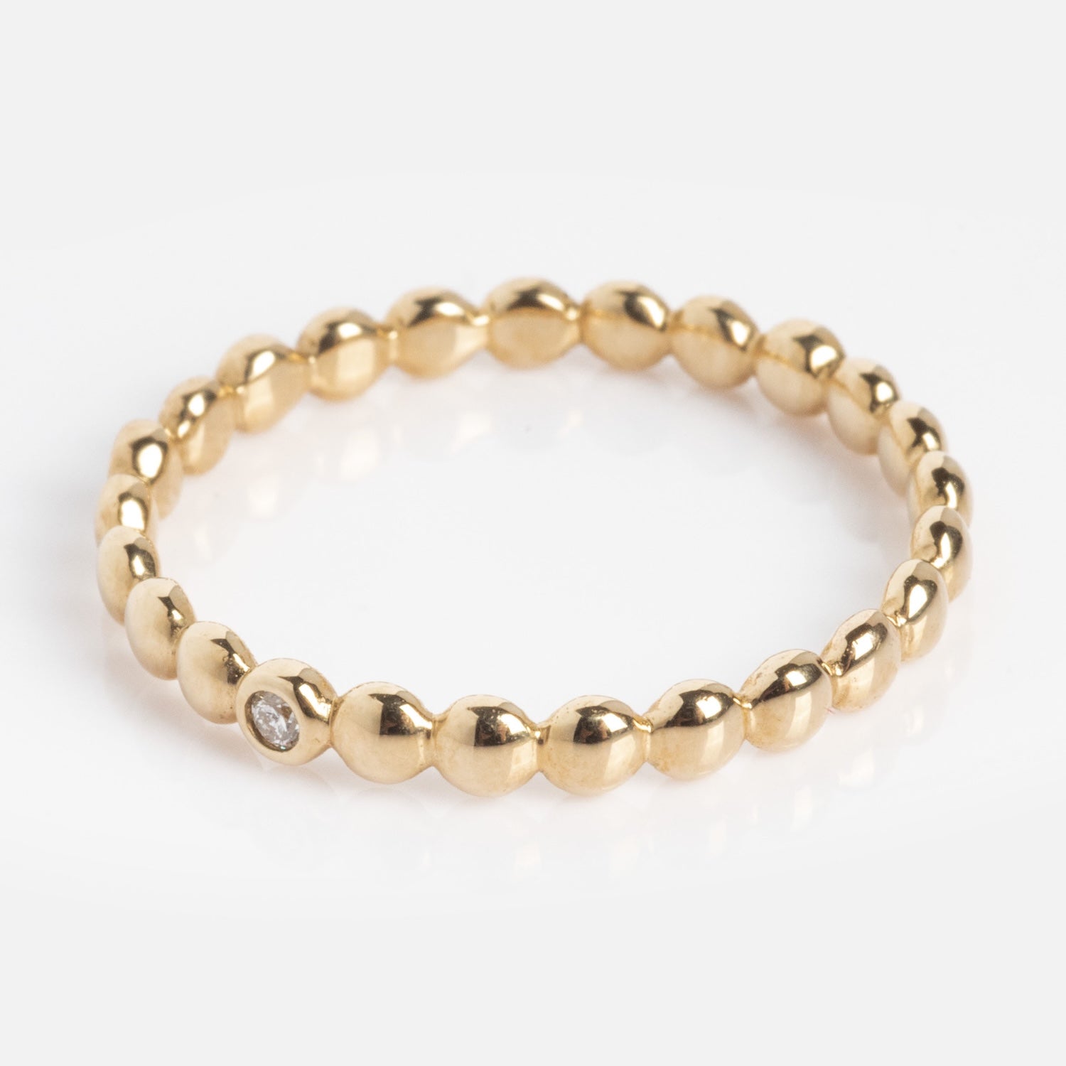 The 10k Hidden Message Morse Code Diamond Band features a thin gold band with round, polished beads and a small diamond set in one bead, shown on a white background.