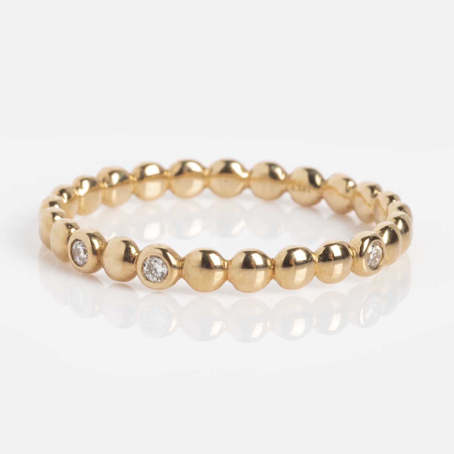 The 10k Hidden Message Morse Code Diamond Band is a delicate gold ring with small round diamonds set among beaded details, shown on a white background.