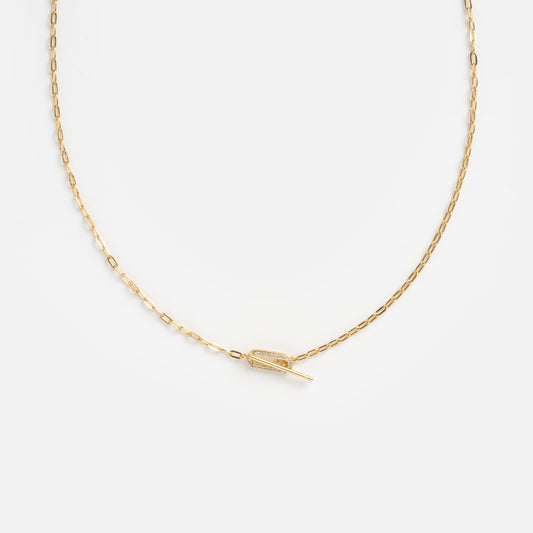 The Jade Pave Necklace features a delicate gold chain with a small, horizontal feather-shaped pendant at the center, displayed on a plain white background.