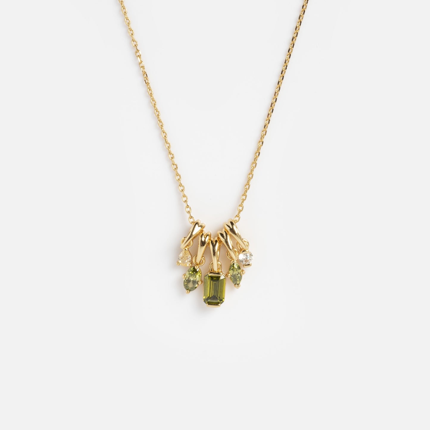 The Shades of You Ombre Birthstone Charm Necklace features a gold chain adorned with small green and clear gemstone charms, shown against a plain white background.