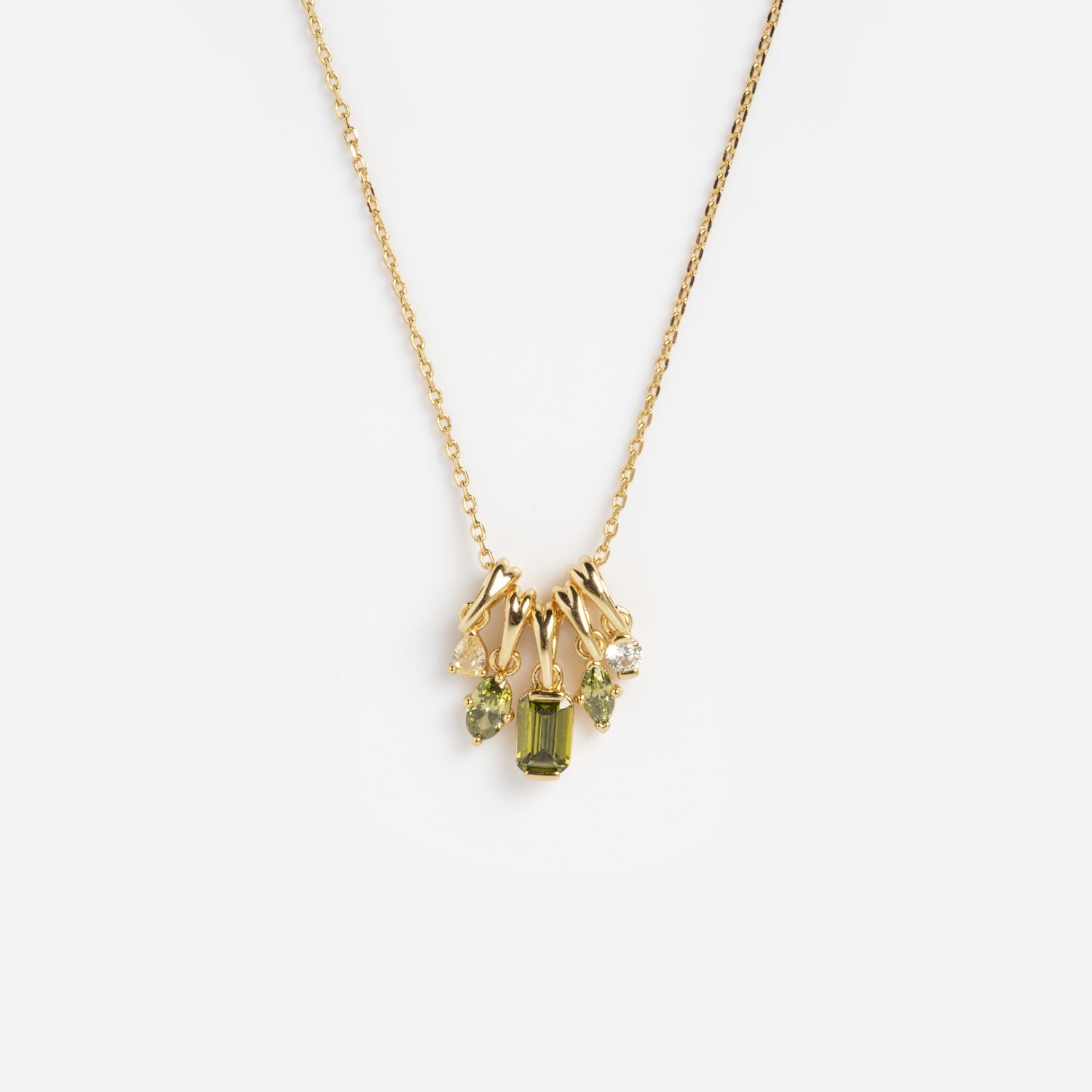 The Shades of You Ombre Birthstone Charm Necklace features a gold chain adorned with small green and clear gemstone charms, shown against a plain white background.