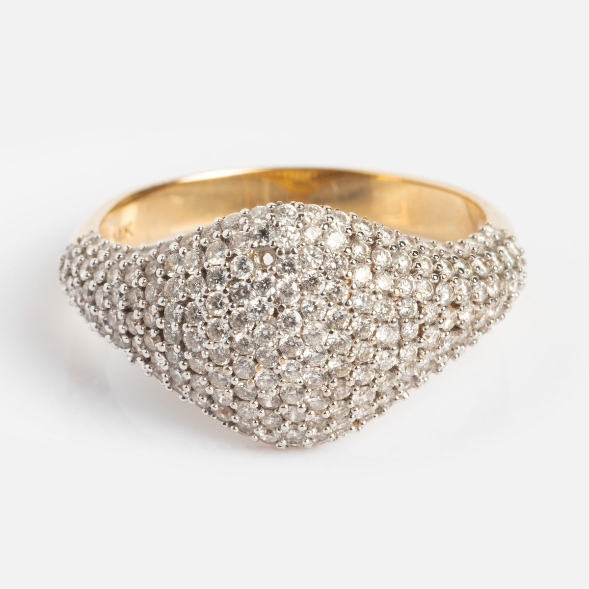The 14k Solid Gold Pave Diamond Signet Ring (sample size 7) features a domed top encrusted with sparkling white diamonds, crafted in solid yellow gold for a textured, shimmering look.
