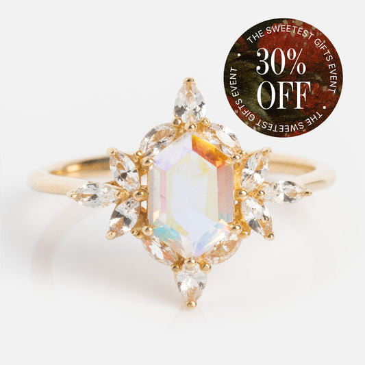 The 14k Angel Aura Quartz Splendor Statement Ring features a large hexagonal angel aura quartz center and sparkling marquise white sapphires. A circular label in the corner reads: 30% OFF THE SWEETEST GIFTS EVENT.
