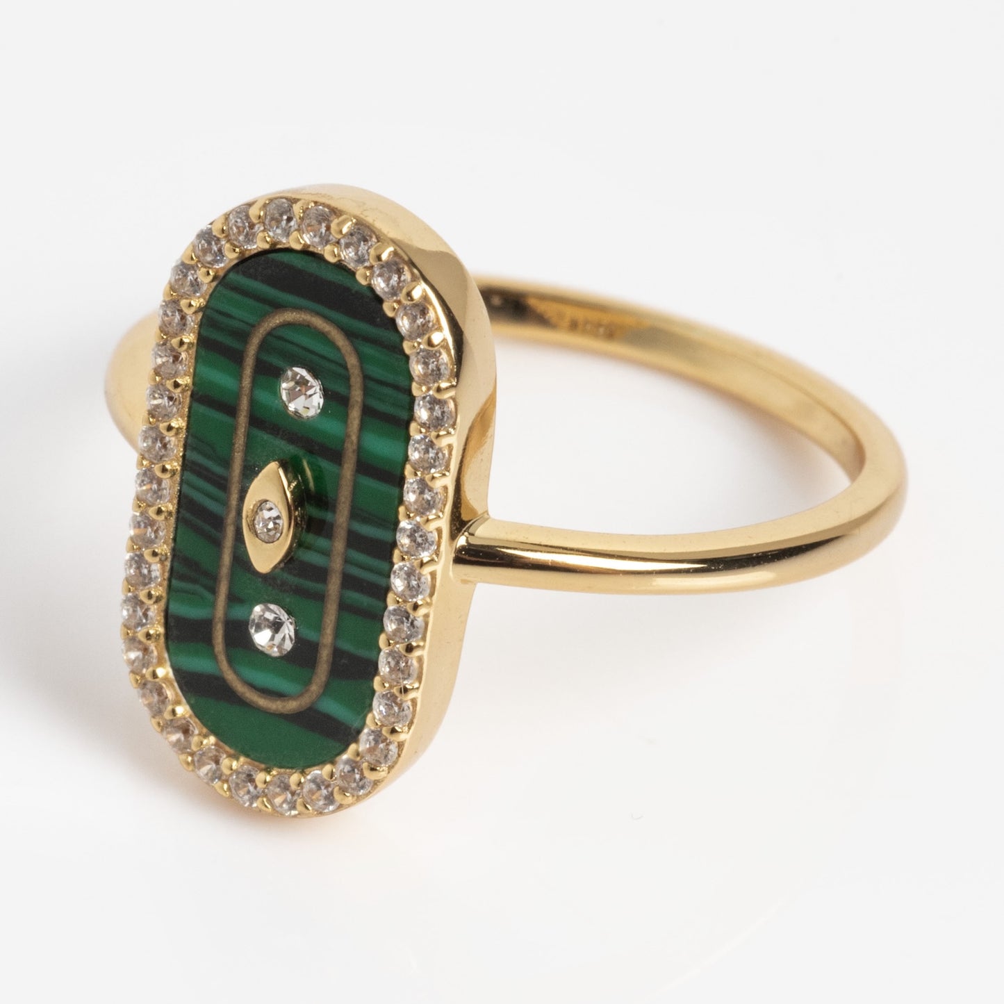 The So Art Deco Cocktail Ring features an oval green malachite centerpiece, three round diamonds, a border of smaller clear stones, and a simple polished band.