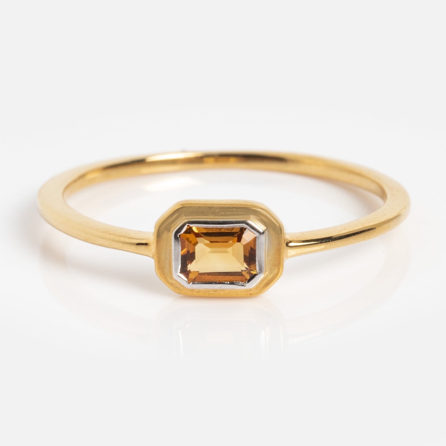 The Matinee Mixed Metal Citrine Ring features a rectangular, golden-yellow citrine gemstone in a simple bezel setting, displayed against a white background.