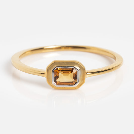 The Matinee Mixed Metal Citrine Ring features a rectangular, golden-yellow citrine gemstone in a simple bezel setting, displayed against a white background.