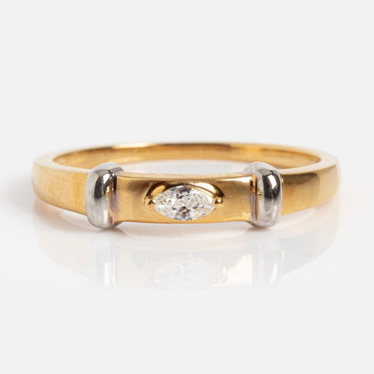 The Hollywood Darling Mixed Metal Band features a gold ring with silver accents flanking a marquise-cut diamond at its center, showcased against a plain white background.