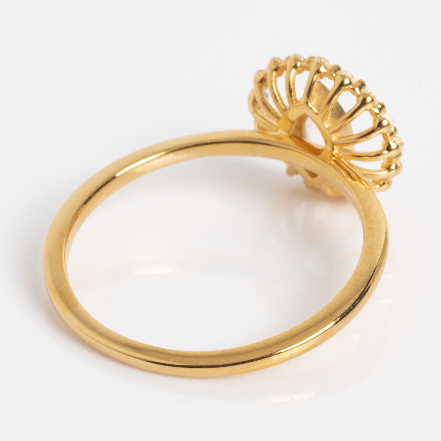 The Silver Screen Starlet Ring features a thin band and an ornate openwork circular setting that resembles a crown or flower, shown from an angle on a white background.
