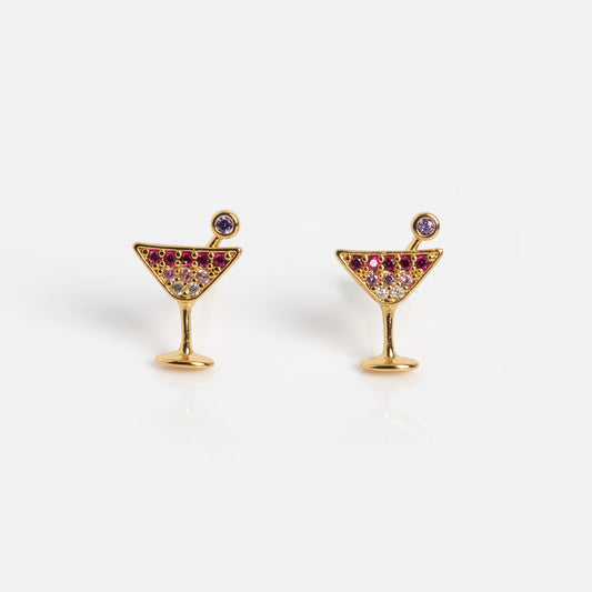 Martini Glass Studs: Gold earrings shaped like cocktail glasses, adorned with pink, purple, and clear gemstones to mimic a drink with garnish. Displayed on a plain white background.