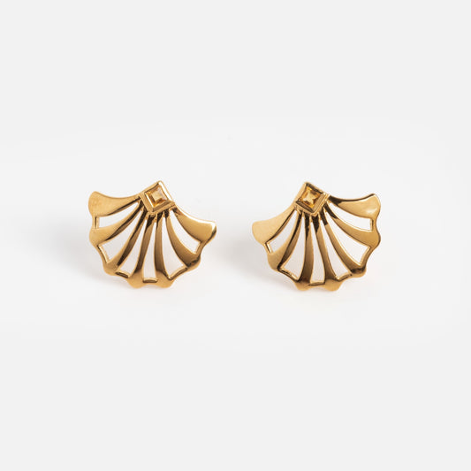 The Showgirl Citrine Fan Earrings are gold, shell-shaped with cut-out sections and a small square detail near the top, shown on a plain white background.
