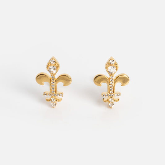 Speakeasy Socialite Studs: a pair of gold fleur-de-lis stud earrings embellished with small clear gemstones, shown on a plain white background.