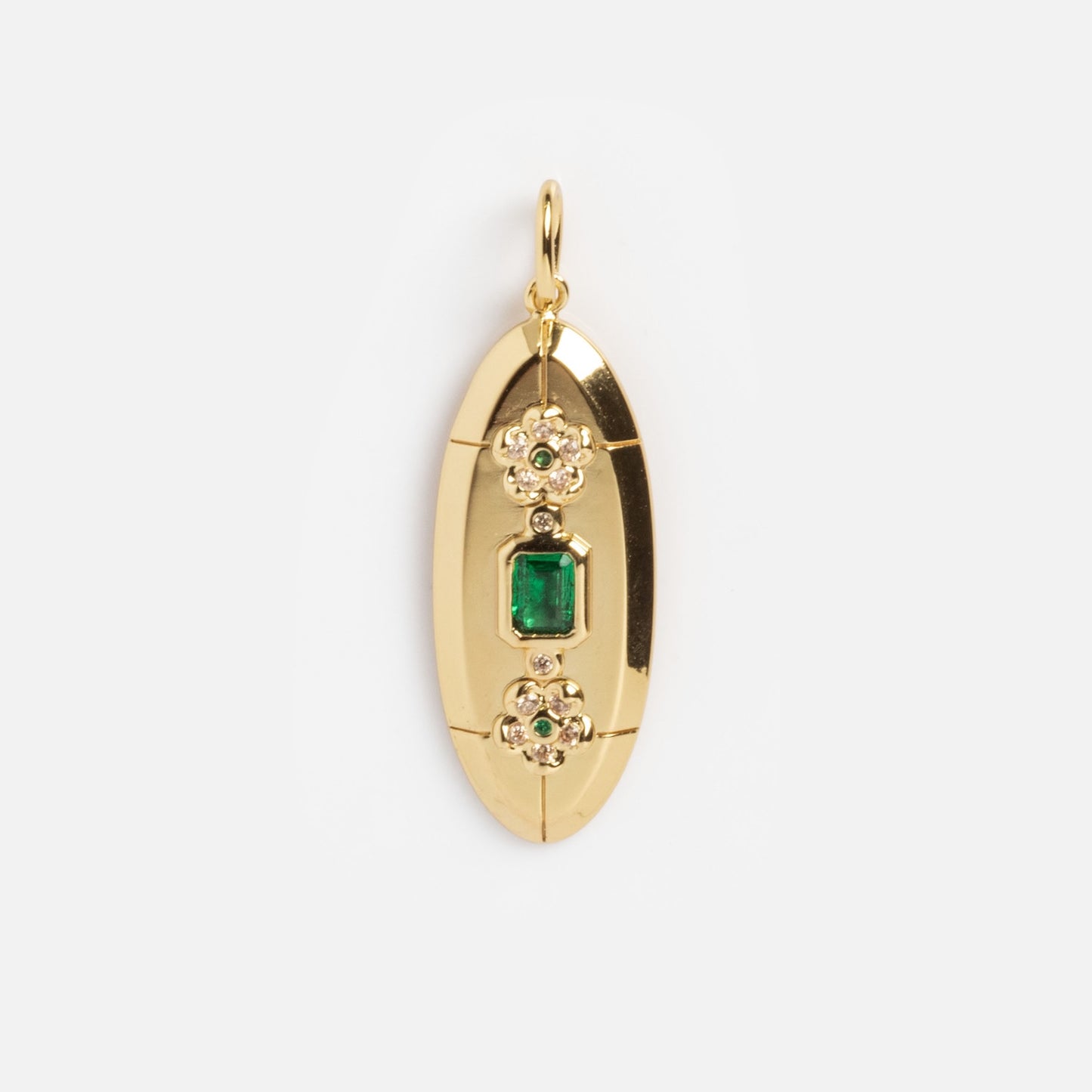 The Vintage Inspired Pendant Charm is a gold oval pendant with a small hoop, featuring two ornate flower designs with white stones and a central rectangular green gemstone for an elegant, polished look.