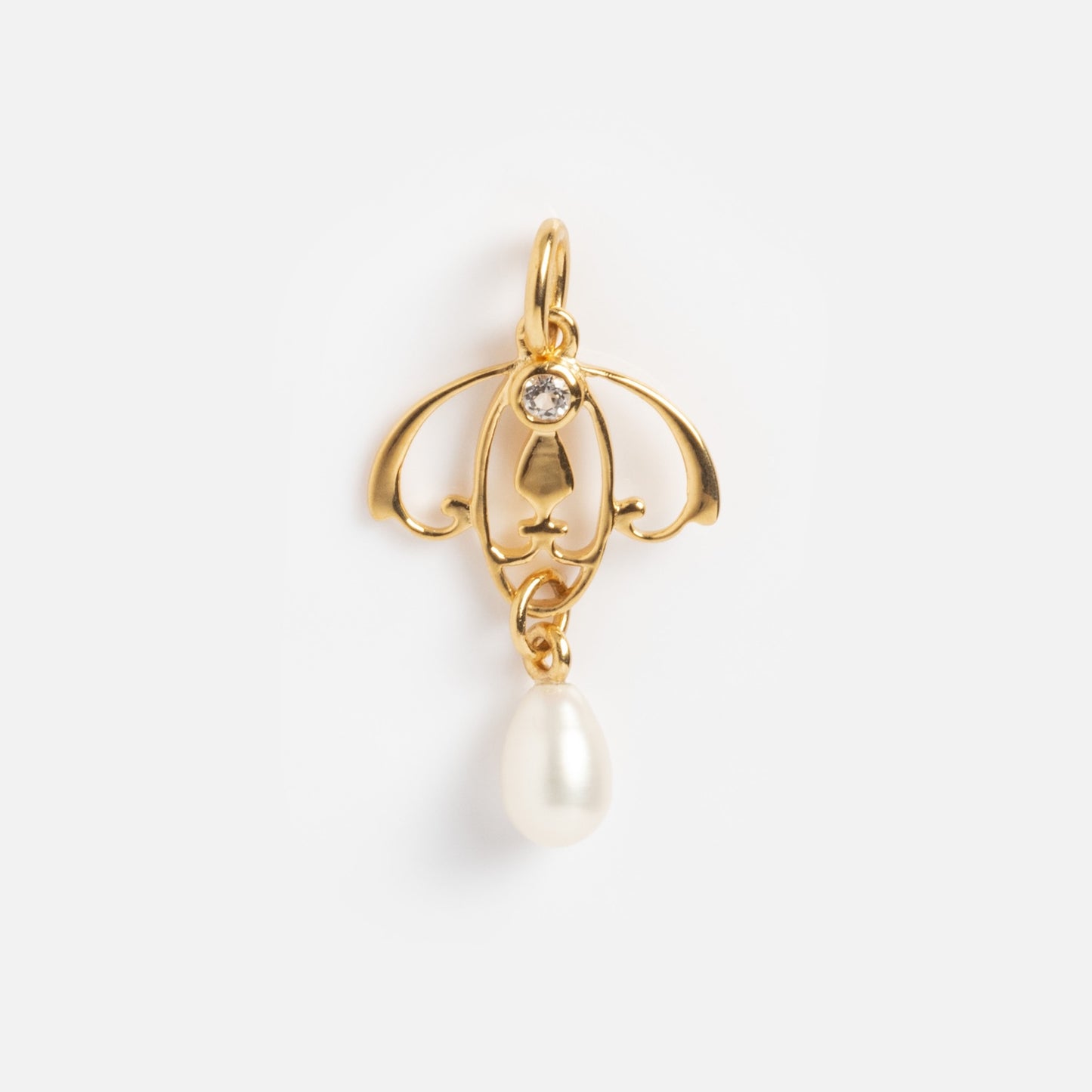 The Vintage Inspired Pendant Charm features a gold intricate design with a small clear gemstone at the top and a single white teardrop-shaped pearl hanging from the bottom, displayed on a plain white background.