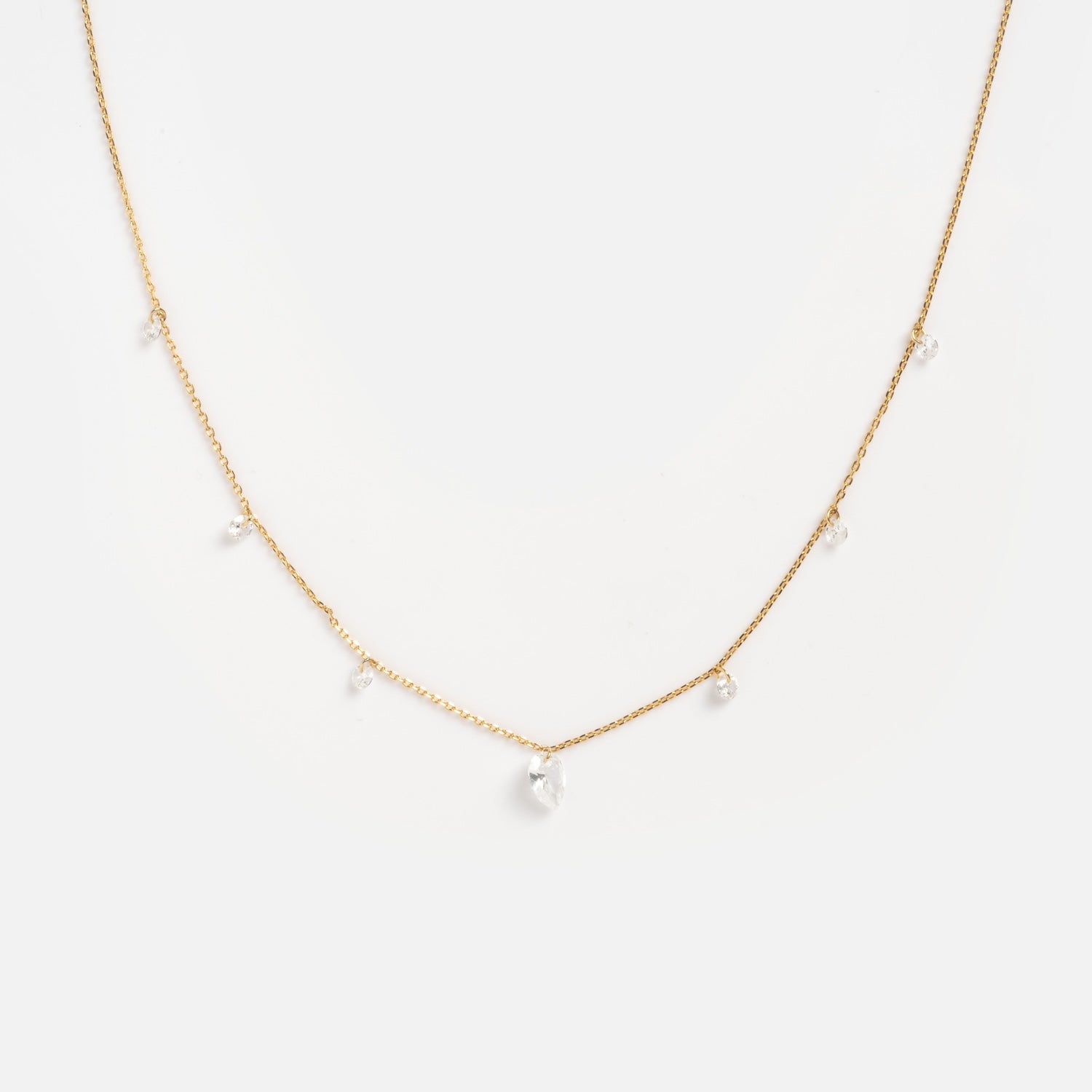 The Floating CZ Station Necklace is a delicate gold chain with evenly spaced clear cubic zirconia drops, shown against a plain white background.