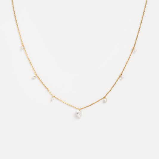 The Floating CZ Station Necklace is a delicate gold chain with evenly spaced clear cubic zirconia drops, shown against a plain white background.