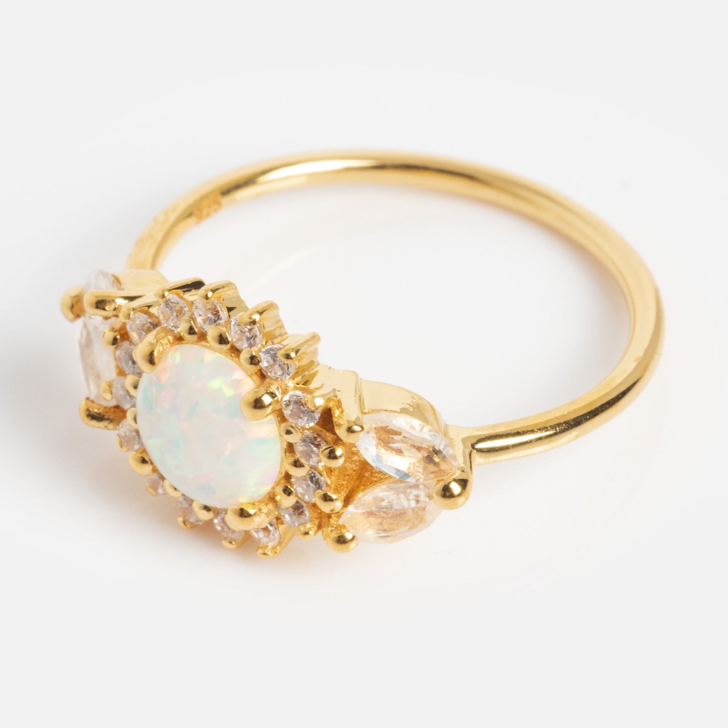 The Opal and Diamond Sunflower Queen Ring features a round opal center stone, small clear diamonds, and two marquise-cut gems on each side, shown against a white background.