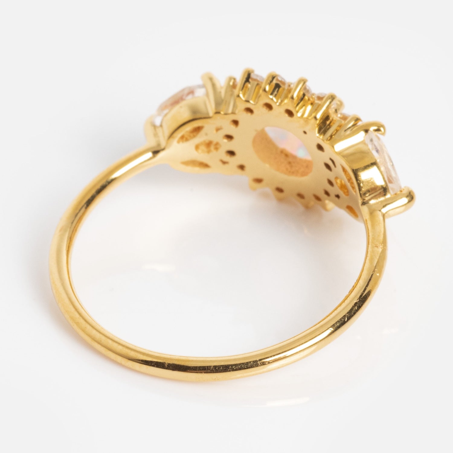 The Opal and Diamond Sunflower Queen Ring features an intricate openwork band and two side stones, shown from the back to highlight the detailed sunflower-inspired setting and the underside of the opal centerpiece.