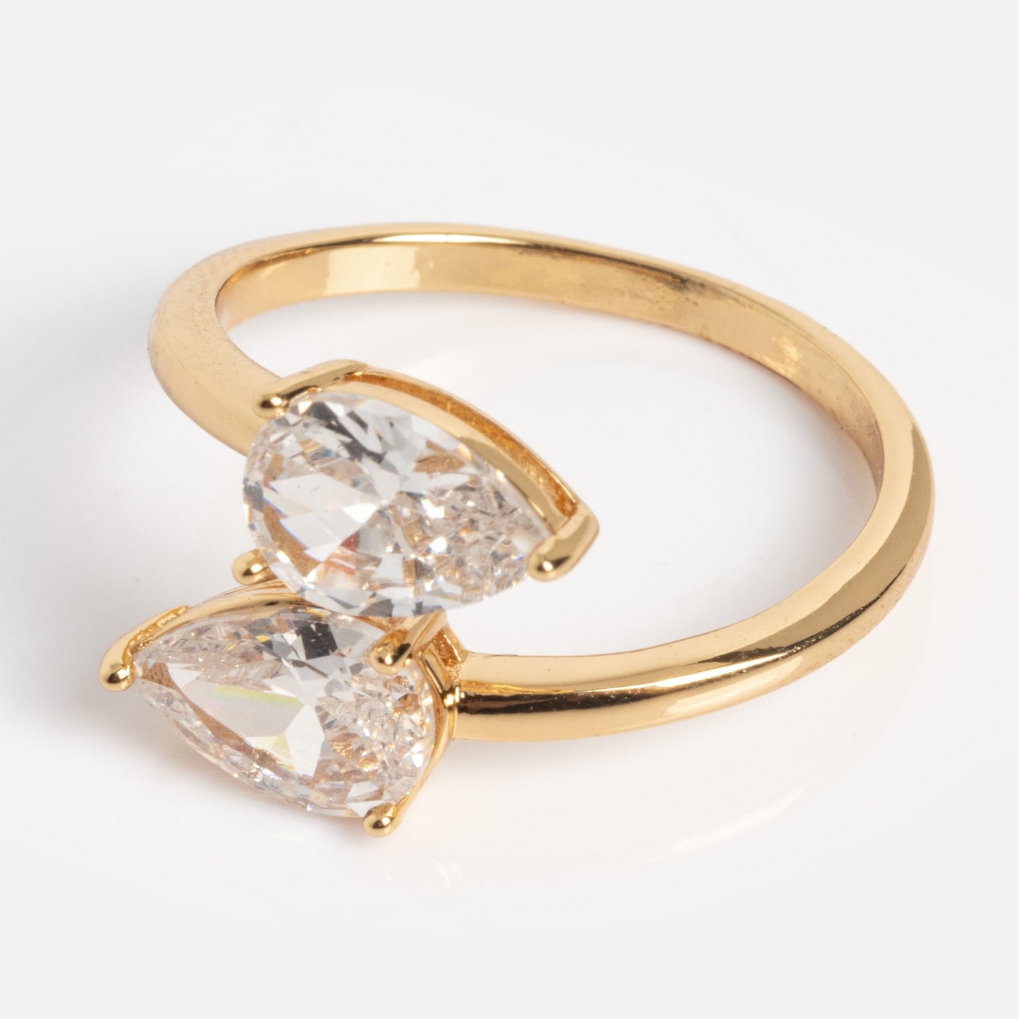 The Crystal Teardrop Wrap Ring is a gold ring with two large, pear-shaped clear stones set side by side, shown on a plain white background.