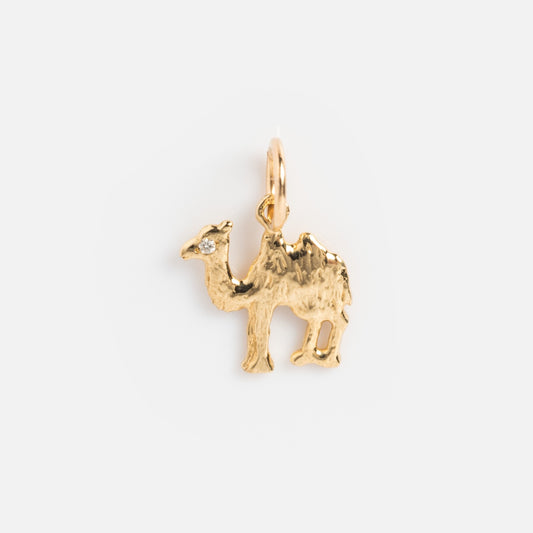 The Sale! 14k Littlest Charms by Charlie and Marcelle features a gold camel-shaped pendant with a tiny gemstone eye, ideal for personalized necklace charms, shown on a simple white background.